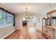 Open dining room with hardwood floors, vintage hutch, and fireplace visible from the dining area at 6731 S Kearney Ct, Centennial, CO 80112