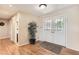 Bright foyer with hardwood floors, a double-door entrance, and an indoor plant, creating a welcoming ambiance at 6731 S Kearney Ct, Centennial, CO 80112