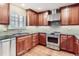 Modern kitchen featuring stainless steel appliances, sleek cabinetry, and stylish tile backsplash at 6731 S Kearney Ct, Centennial, CO 80112