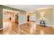 Open-concept living space with hardwood floors, seamlessly connecting the foyer, dining area, and living room at 6731 S Kearney Ct, Centennial, CO 80112