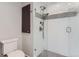 Glass shower with a tiled backsplash and dual shower heads with a gray floor at 6731 S Kearney Ct, Centennial, CO 80112