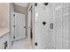 Modern bathroom features a glass shower with white and black tiling, and matte black hardware at 3219 W 19Th Ave # 3, Denver, CO 80204