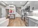 Open-concept living space features stainless steel appliances, modern staircase, and contemporary decor at 3219 W 19Th Ave # 3, Denver, CO 80204