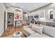 Open living space with modern kitchen, breakfast bar, stainless steel appliances, and contemporary decor at 3219 W 19Th Ave # 3, Denver, CO 80204