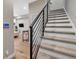 Modern staircase with sleek metal railings and carpeted steps leading to the upper level at 3219 W 19Th Ave # 3, Denver, CO 80204