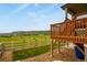 Backyard with a deck overlooking serene pasture and rolling hills at 2549 Loon Cir, Castle Rock, CO 80104