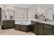 Elegant bathroom featuring a soaking tub, granite countertops, and ample cabinet space at 2549 Loon Cir, Castle Rock, CO 80104