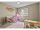 Bright bedroom featuring a playful pink tent, desk, and storage shelves at 2549 Loon Cir, Castle Rock, CO 80104
