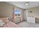 Charming bedroom with a pink accent and scenic view from the window at 2549 Loon Cir, Castle Rock, CO 80104
