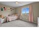 Bright bedroom with a twin bed, scenic window view, and soft, colorful accents at 2549 Loon Cir, Castle Rock, CO 80104