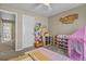 Cozy bedroom with fun decor, toy storage, and a glimpse into the hallway bathroom at 2549 Loon Cir, Castle Rock, CO 80104