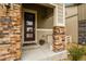 Welcoming front entrance with a stone-accented porch and a stylish, modern door at 2549 Loon Cir, Castle Rock, CO 80104