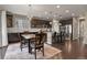 Well-appointed kitchen and dining area featuring dark cabinets, stainless steel appliances, and a stylish chandelier at 2549 Loon Cir, Castle Rock, CO 80104