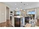 Open-concept kitchen with a large island and stainless steel dishwasher, seamlessly flowing into the dining and living areas at 2549 Loon Cir, Castle Rock, CO 80104