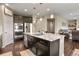 Contemporary kitchen boasts stainless steel appliances, dark cabinetry, granite island, and an open layout at 2549 Loon Cir, Castle Rock, CO 80104
