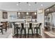 Stylish kitchen with stainless steel appliances, dark cabinetry, and a granite island with seating for four at 2549 Loon Cir, Castle Rock, CO 80104