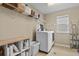 Functional laundry room with modern washer/dryer and ample storage shelving at 2549 Loon Cir, Castle Rock, CO 80104