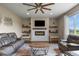 Cozy living room with fireplace, floating shelves, and comfortable leather seating at 2549 Loon Cir, Castle Rock, CO 80104