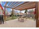 Outdoor patio space with wooden pergola, picnic table, and playset, ideal for Gathering gatherings and playtime at 15104 E Utah Pl, Aurora, CO 80012