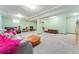 Spacious basement featuring ample room for recreation and relaxation, with light green walls and neutral carpet at 15104 E Utah Pl, Aurora, CO 80012