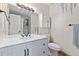 Bright bathroom with a modern vanity, decorative mirror, and neutral tones at 15104 E Utah Pl, Aurora, CO 80012