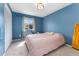 Comfortable bedroom with blue walls, carpet, and a window for natural light at 15104 E Utah Pl, Aurora, CO 80012