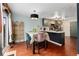 Bright dining area with table, chairs, hardwood floors, and a view to the kitchen at 15104 E Utah Pl, Aurora, CO 80012