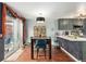 Charming dining area open to the kitchen with a modern light fixture and access to the backyard at 15104 E Utah Pl, Aurora, CO 80012