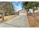 A ranch-style home with a long driveway, two car garage, brick facade, and mature trees at 15104 E Utah Pl, Aurora, CO 80012