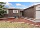 Close up of home's brick facade and well-maintained landscaping at 15104 E Utah Pl, Aurora, CO 80012
