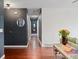 Long hallway with dark gray walls and hardwood floors at 15104 E Utah Pl, Aurora, CO 80012