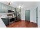 Charming kitchen featuring stainless steel appliances, and stylish green cabinets at 15104 E Utah Pl, Aurora, CO 80012