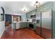 Spacious kitchen featuring stainless steel appliances and green cabinets at 15104 E Utah Pl, Aurora, CO 80012