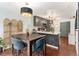 Stylish kitchen and dining area featuring stainless steel appliances and hardwood floors at 15104 E Utah Pl, Aurora, CO 80012