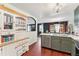 Kitchen with stainless steel appliances, olive green cabinets, and a view to living space at 15104 E Utah Pl, Aurora, CO 80012