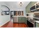 Modern kitchen with stainless steel appliances and opening to the dining room at 15104 E Utah Pl, Aurora, CO 80012