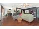 Open-concept living area with hardwood floors, modern decor, and a view into the kitchen at 15104 E Utah Pl, Aurora, CO 80012