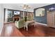 A living room featuring a brick fireplace, wood floors and stylish furniture for a cozy and inviting atmosphere at 15104 E Utah Pl, Aurora, CO 80012