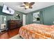 Comfortable main bedroom with hardwood floors, TV, and window providing ample light at 15104 E Utah Pl, Aurora, CO 80012