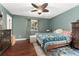 Primary bedroom with wood floors, neutral walls, and a patterned accent rug at 15104 E Utah Pl, Aurora, CO 80012