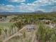 Beautiful aerial view of a modern home nestled among lush greenery, offering mountain views and a serene, secluded setting at 9288 Krashin Dr, Conifer, CO 80433