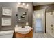 Charming bathroom features a gray vanity and shower with tiled floors at 9288 Krashin Dr, Conifer, CO 80433