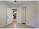 Bedroom with a door open to an en-suite bathroom and a neutral color palette at 9288 Krashin Dr, Conifer, CO 80433