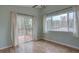 Bedroom featuring sliding glass door to deck with two large windows and hardwood floors at 9288 Krashin Dr, Conifer, CO 80433