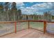 Wooden deck overlooking fenced yard and trees at 9288 Krashin Dr, Conifer, CO 80433