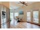 Bright dining area with stainless steel refrigerator, wood floors, and walkout to deck at 9288 Krashin Dr, Conifer, CO 80433