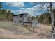 Exterior of home featuring fenced yard and trees at 9288 Krashin Dr, Conifer, CO 80433