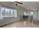 Open office area with hardwood floors, large window with view, and black metal railing at 9288 Krashin Dr, Conifer, CO 80433