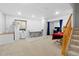 Finished basement with carpet flooring and painted white walls, plus stairs with wood railing at 2805 Masters Ln, Castle Rock, CO 80104