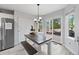 Dining area with wood table, bench seating, a stainless steel refrigerator, and sliding door access to backyard at 2805 Masters Ln, Castle Rock, CO 80104